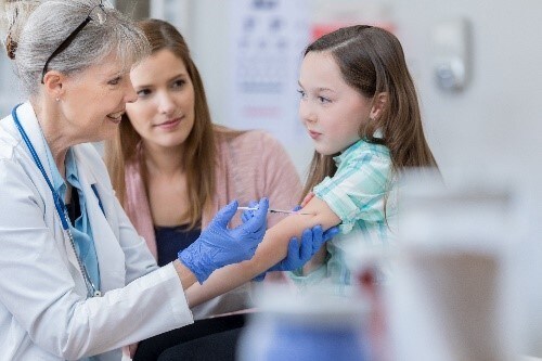 Girl getting a vaccine A girl getting a vaccine